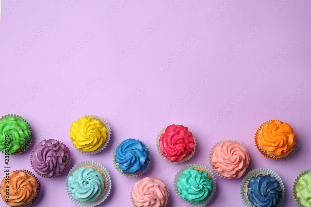 Different cupcakes on color background