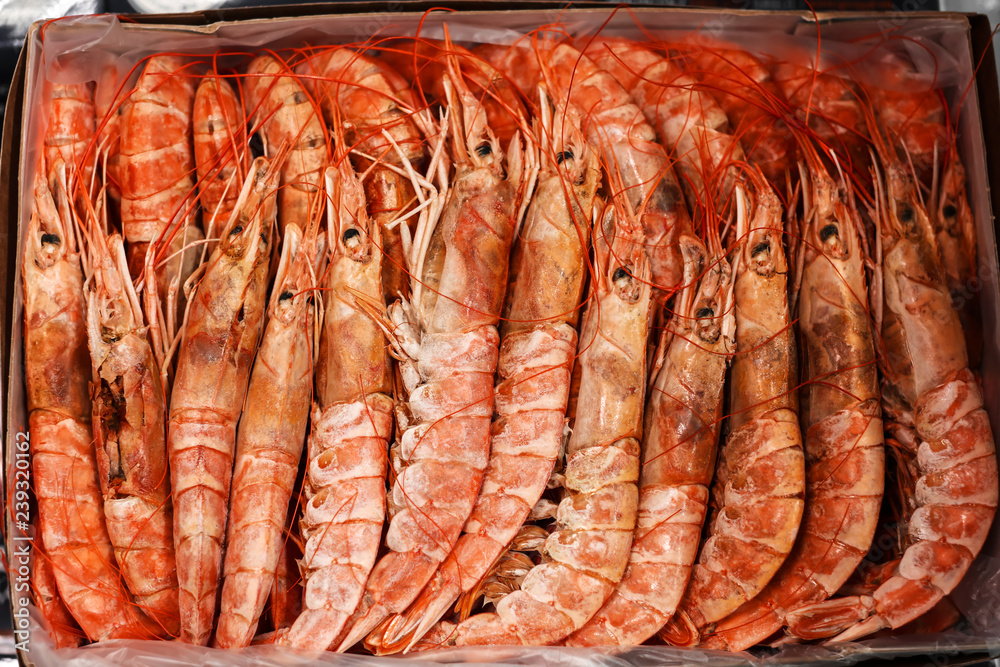 Frozen boiled shrimps in box, top view