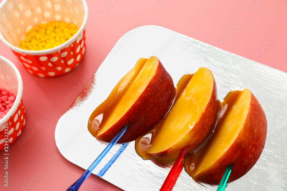 Candy apple wedges with sprinkles on color background