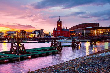 Wall Mural - Waterfront at night in Cardiff, UK. Sunset colorful sky with Wales Millennium Center