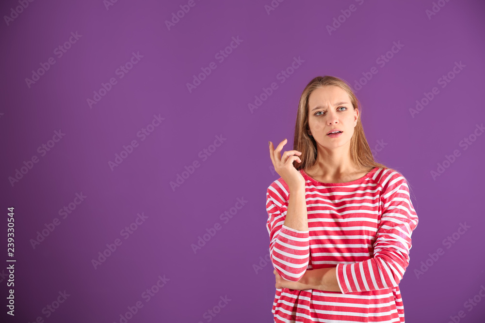 Thoughtful young woman on color background