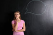 © Pixel-Shot - Thoughtful young woman and blank speech bubble drawn on blackboard