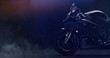 Black modern sports motorcycle front part detail on dark background with smoke (3D illustration)