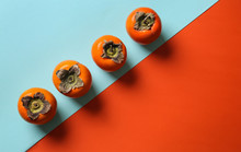 Tasty Ripe Persimmons On Color Background, Top View