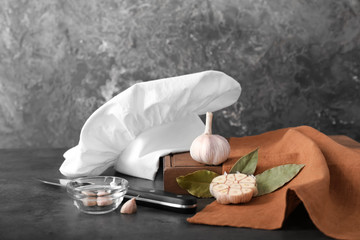 Composition with chef's hat on kitchen table