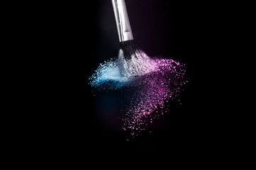 purple and blue ocean powder color splash and brush for makeup artist or graphic design in black background, look like a lively and joyful mood.