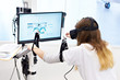 Woman on stand with virtual reality device for rehabilitation