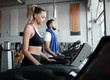 © ASDF - beautiful sports people work on the treadmill in the gym