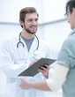 © ASDF - podiatrist writing a prescription to her patient.
