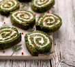 © zi3000 - Spinach roulade stuffed with cream cheese and smoked salmon sliced on a white board.  Delicious appetizer, party food