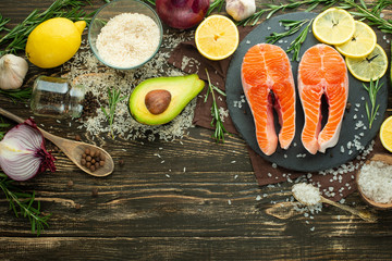 Wall Mural - Fresh fish steak trout, salmon, salmon, red fish meat. With ingredients and vegetables on a wooden background, Flat-lay, Clean and healthy food