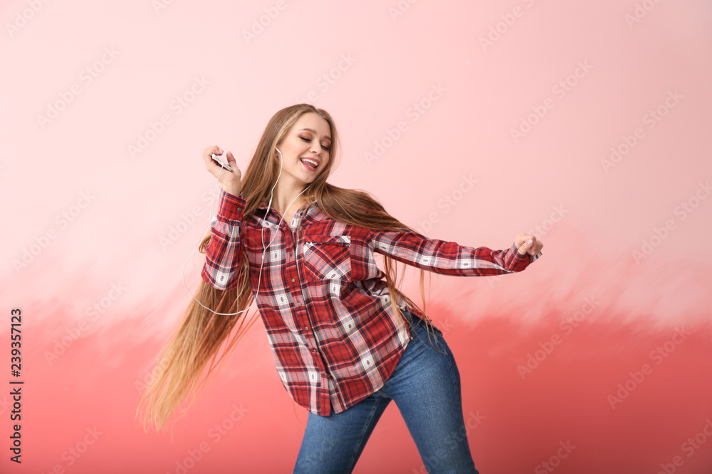 Beautiful young woman dancing on color background