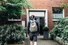 A Tourist Goes To The Guesthouse Or Hostel In Order To Stay In A Room That He Booked Or A Student With A Backpack Returns Home After His Studies At The Institute Or On Vacation.