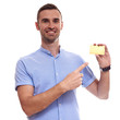 © Elena Kharichkina - Happy smiling young man showing credit card isolated on white background