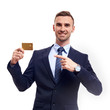 © Elena Kharichkina - Happy smiling young man showing credit card isolated on white background