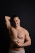 © Pixel-Shot - Young man with deodorant on dark background