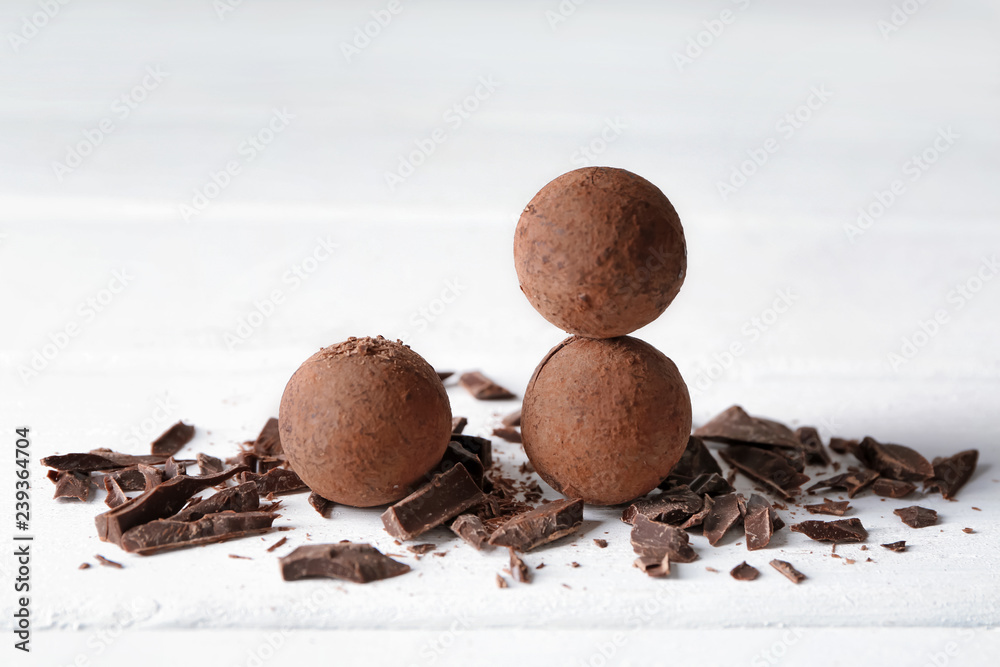 Tasty sweet truffles on white table