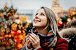 © Masson - Beautiful adult girl with cup of hot drink at Christmas fair in Dresden, Germany