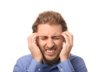 Young man suffering from headache on white background