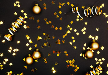 Wall Mural - Beautiful christmas golden silver deco baubles on dark black background. Flat lay design. Copy Space. Horizontal.