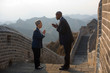 © Erickson Stock - Chinese businessman and woman greeting each other traditionally at the Great Wall of China.