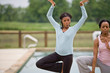 © Erickson Stock - Portrait of two young woman doing yoga.