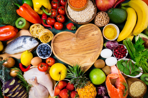 Background healthy food for heart. Fresh fruits, vegetables, fish, meat, berries and cereals. Healthy food, diet and healthy life concept. Top view, copy space