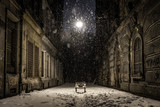 Fototapeta Uliczki - Empty bench on a dark alley