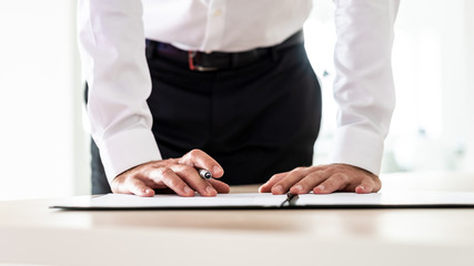 Wall Mural - Business employer signing an application form