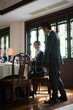© Erickson Stock - Businessman and businesswoman looking at each other inside a restaurant.