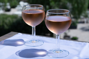 Rose wine of Provence, France, served cold on outdoor terrace in two wine glasses