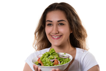 Healthy lifestyle young girl holding a bowl with fresh salad smiling happy