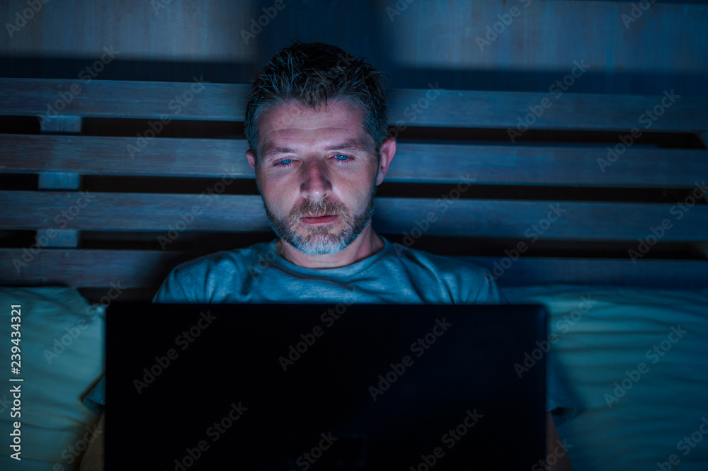 attractive and relaxed internet addict man networking concentrated late ...