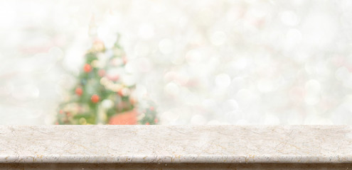 Leinwandbilder - White marble table top at blur bokeh christmas tree decor with string light background when show falling,Winter holiday greeting card.