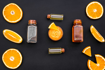 citrus orange cosmetic for natural spa bath on black table background top view pattern