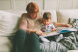 A grandmother and her grandson reading together. 