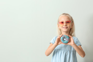 Sticker - Cute little girl with donut on light background