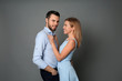 © Pixel-Shot - Stylish young couple on grey background