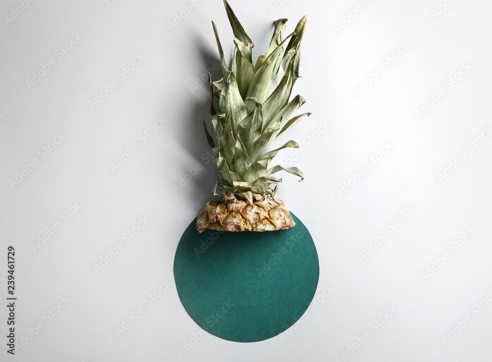 Ripe cut pineapple and color circle on white background