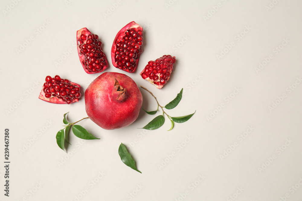 Composition with ripe pomegranate on white background