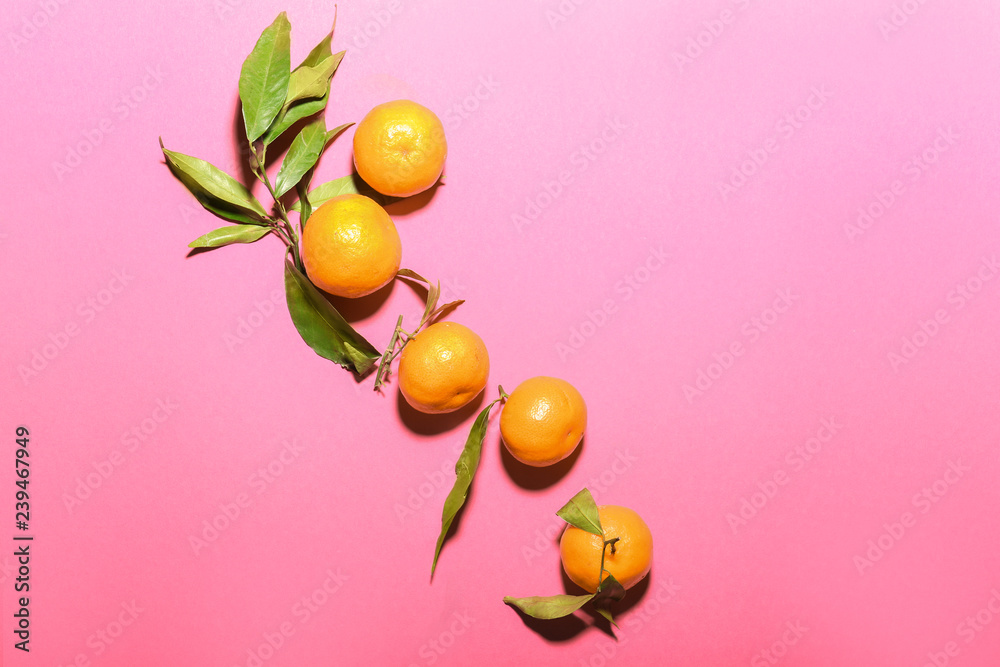 Ripe tasty tangerines on color background