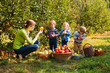 © oksix - Teacher with preschoolers in the apple garden