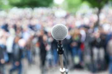 Wall Mural - Microphone in focus against blurred crowd