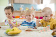 © Andrey Kuzmin - Kids eating in kindergarten or day care centre