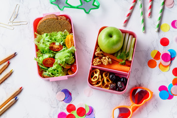 Wall Mural - Lunch box with salad and healthy food for school. Top view image with color pencils and children's glasses