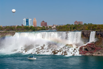 Wall Mural - Cruise Boat and American Falls from Niagara Falls with hot-air balloon in background - Ontario, Canada