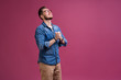 © opolja - Portrait of a satisfied young man celebrating success isolated over pink background.