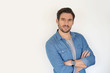 © goodluz - Very handsome casual man with arms crossed standing on white background