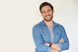 © goodluz - Very handsome casual man smiling and standing on white background