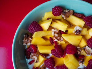 Delicious fruit bowl with red background